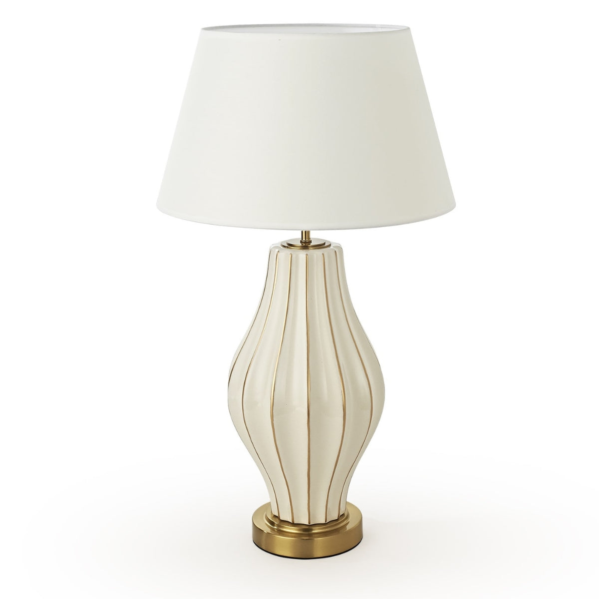Decorative table lamp with ribbed design and white shade on a white background
