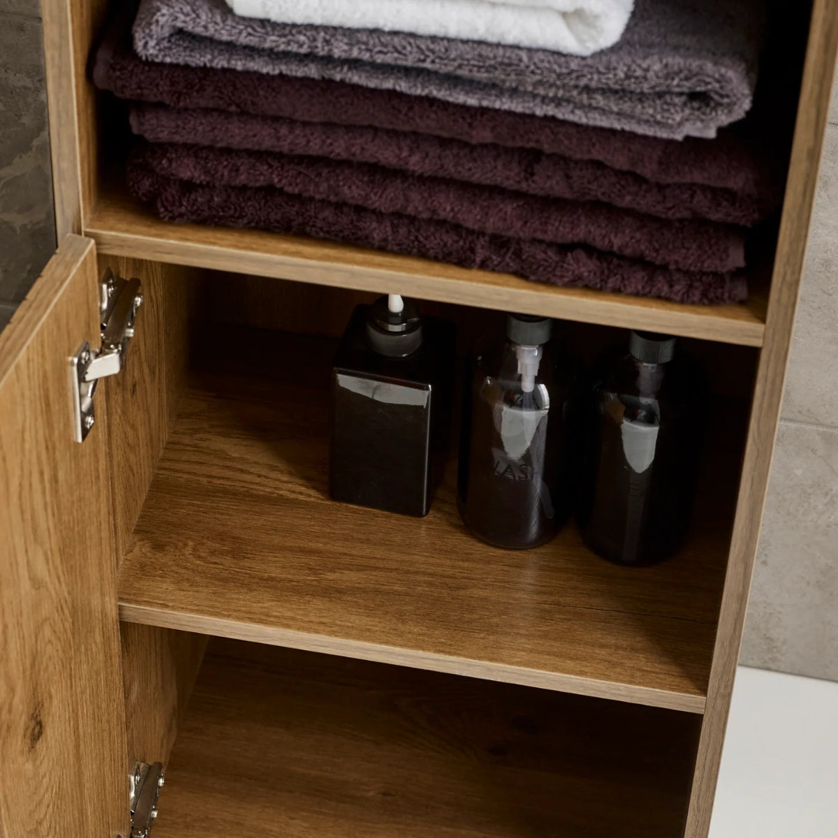 Hampshire wooden cabinet with folded towels on top and bottles inside.