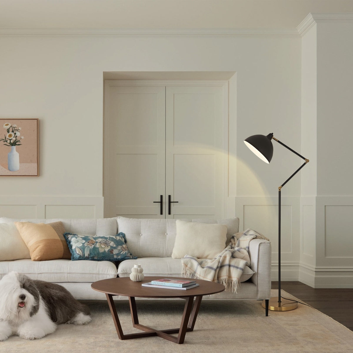 Modern living room with a white sofa, wooden coffee table, and floor lamp.