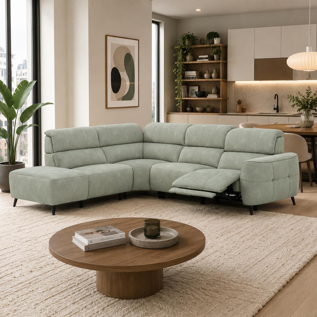 Mosley green sectional sofa with a chaise lounge and an extended reclining seat, shown in a modern, sunlit living room with a round wooden coffee table and a textured cream rug.