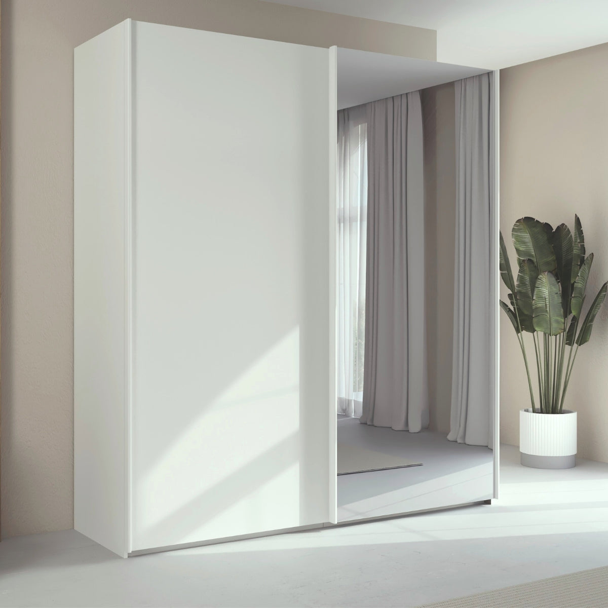 Trixie white wardrobe with a mirror in a minimalistic room with a plant.