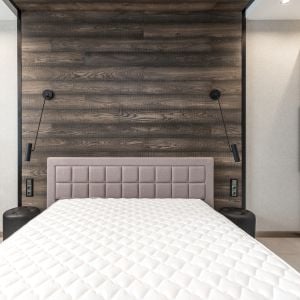 a double mattress against a panelled wall