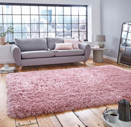 a pink rug on bedroom floor