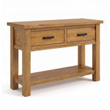 Ailbhe rustic oak console table with two drawers featuring black metal handles and a lower open shelf, shown on a white background.