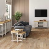 Modern living room with grey sofa, wooden coffee table, and TV on wall.