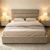 Catalina modern upholstered bed with a tall segmented headboard and matching footboard, shown in a styled bedroom setting with two bedside lamps, beige bedding, and a grey throw blanket.