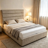 Catalina modern platform bed with a tall, padded upholstered headboard and matching base, dressed in white bedding and a grey throw blanket, set in a softly lit bedroom.
