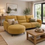 Dutton yellow sofa in a living room with a wooden coffee table and decorative items.