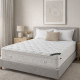 Bed with white mattress and gray frame in a bedroom setting