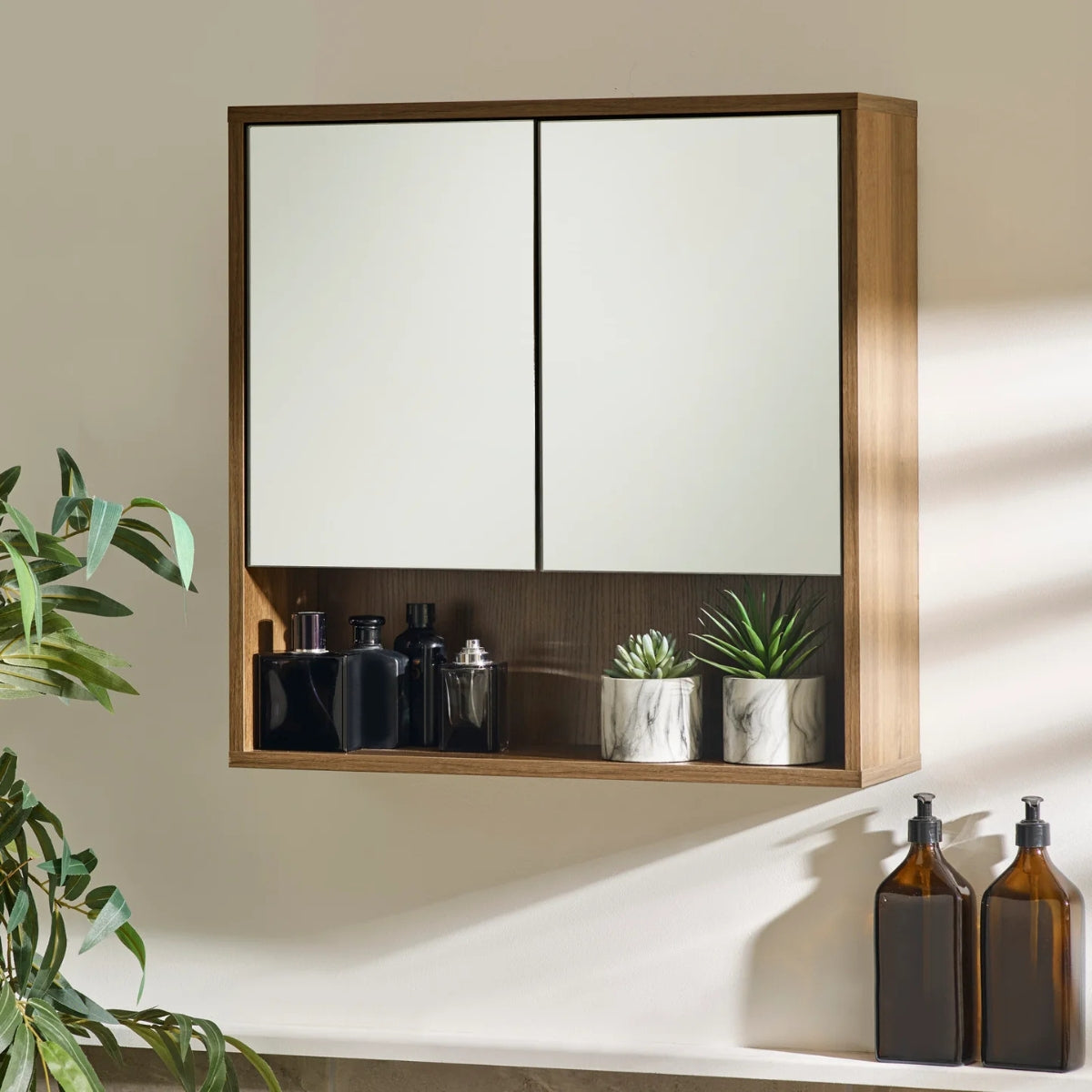 Hampshire wooden cabinet with white doors containing bottles and plants on a neutral wall.