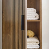 Hampshire Wooden cabinet with open door revealing folded clothes inside.