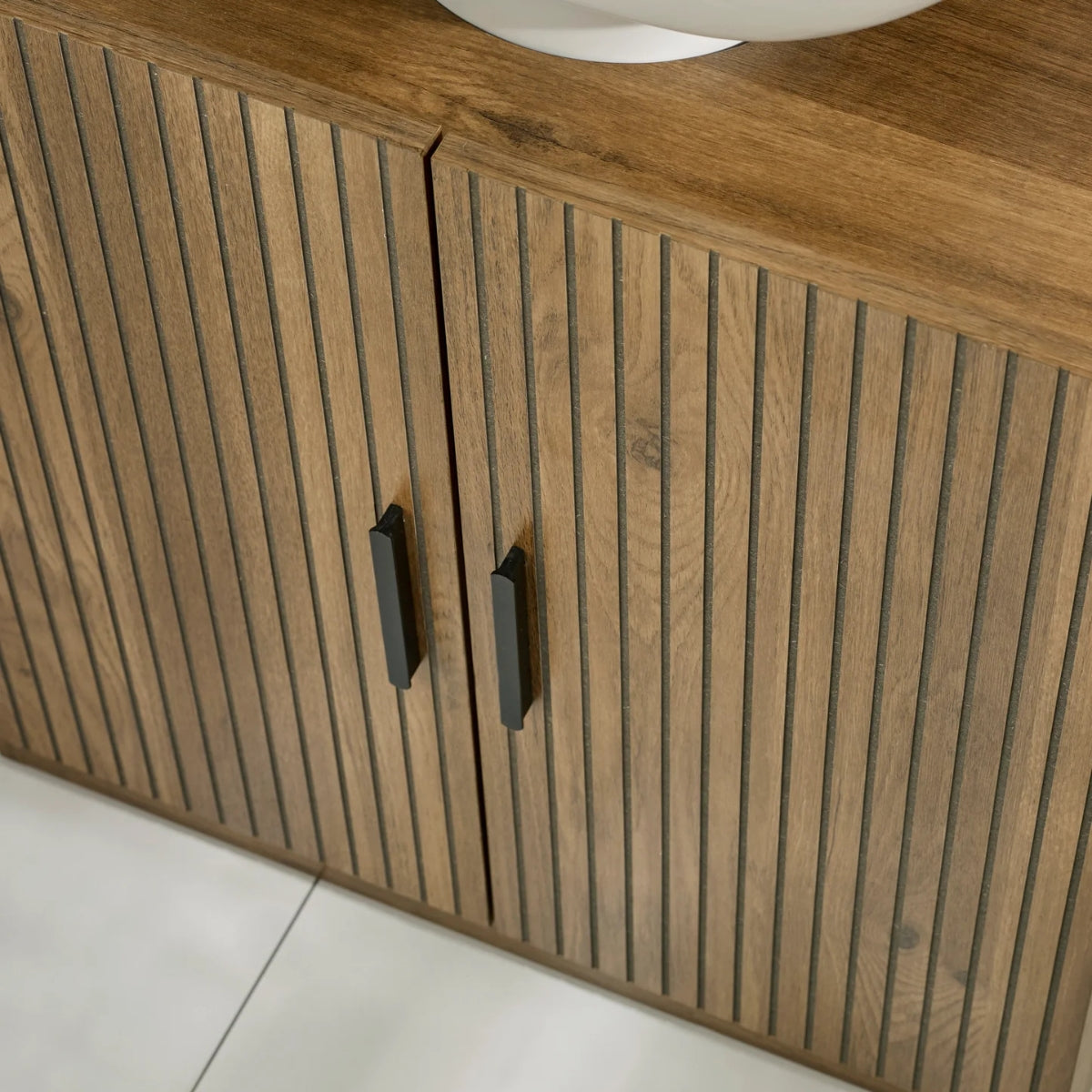 Hampshire wooden cabinet with slatted design and black handles on a light background