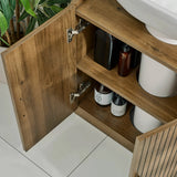 Hampshire wooden bathroom cabinet with open door revealing toiletries on shelves.