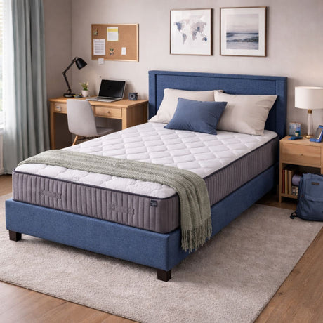 Bedroom with a mattress on a blue upholstered bed, desk, and decor elements.
