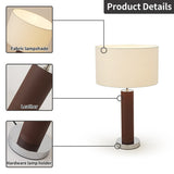 Table lamp with fabric lampshade, leather base, and metal hardware on a white background.
