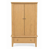 Maldon two-door wooden cabinet with a single drawer at the bottom, finished in a light natural oak finish with small silver knobs, shown against a plain white background.