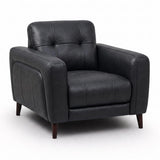 Manhattan black leather armchair with a tufted backrest, padded seat cushion, and dark wooden legs, shown on a plain white studio background.
