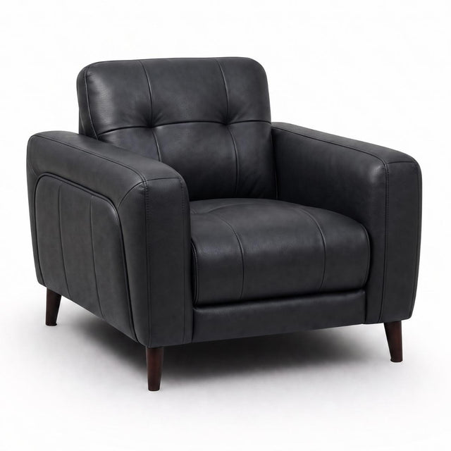 Manhattan black leather armchair with a tufted backrest, padded seat cushion, and dark wooden legs, shown on a plain white studio background.