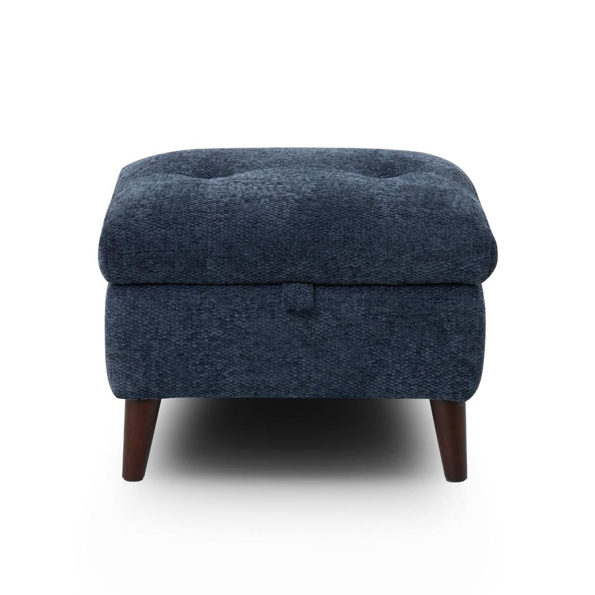 Manhattan square upholstered ottoman in dark navy blue textured fabric with a tufted top and short dark wooden legs, shown against a plain white background.