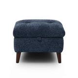 Manhattan square upholstered ottoman in dark navy blue textured fabric with a tufted top and short dark wooden legs, shown against a plain white background.