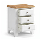 Mimosa three-drawer nightstand with a white painted body, a natural wood top, and three silver round drawer knobs, shown on a white background.