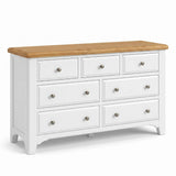 Mimosa white wooden dresser with a natural oak top and seven drawers, shown on a clean white background.