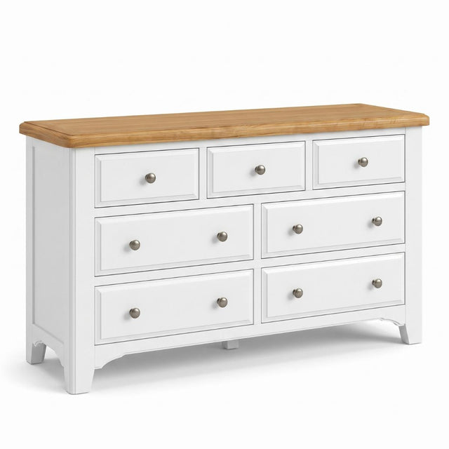 Mimosa white wooden dresser with a natural oak top and seven drawers, shown on a clean white background.