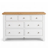 Mimosa white seven-drawer dresser with a natural oak wood top and small round silver knobs, shown against a plain white background.