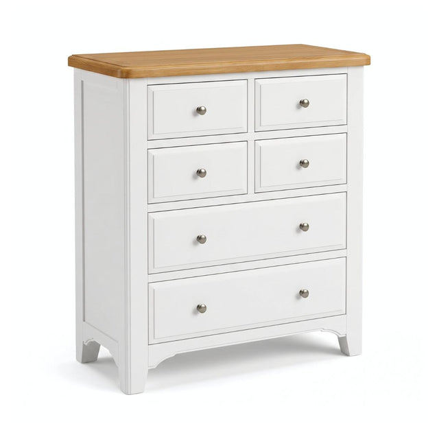 Mimosa white six-drawer chest of drawers with a natural light wood top and small round silver knobs, shown on a clean white background.