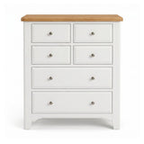 Mimosa white six-drawer chest of drawers with a natural light wood top and small round silver knobs, shown against a plain white background.