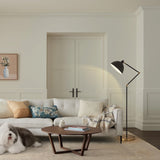 Modern living room with a white sofa, wooden coffee table, and floor lamp.