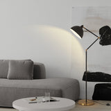 Modern living room with gray sofa, white coffee table, and black floor lamp.