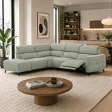 Mosley green sectional sofa with a chaise lounge and an extended reclining seat, shown in a modern, sunlit living room with a round wooden coffee table and a textured cream rug.
