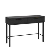 Rosalind black dressing table with two drawers featuring textured gold handles, supported by slim black legs and a lower support rail, shown on a plain white background.