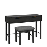 Rosalind black dressing table desk with two drawers and gold handles, paired with a matching stool featuring a gray upholstered seat, shown on a plain white background.