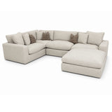 Solara grey sectional sofa with cushions on a white background.