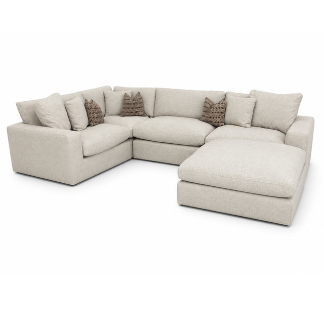 Solara grey sectional sofa with cushions on a white background.