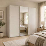 Trixie beige modern bedroom with a large white wardrobe and bed.