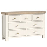 Wilson cream dresser with six drawers and a oak top on a white background.