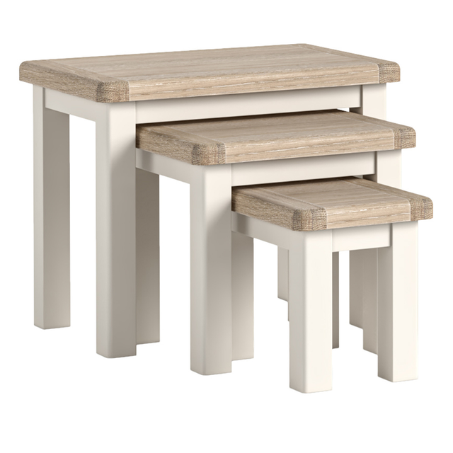 Set of the Wilson three wooden nesting tables with a cream base on a white background.