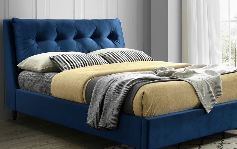 Blue tufted velvet bed frame.