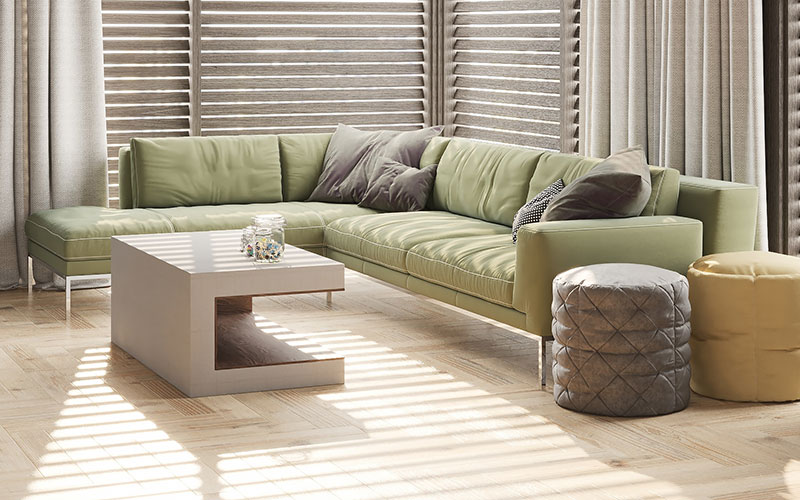 Olive green fabric corner sofa with silver legs.