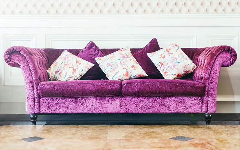 Purple chesterfield sofa.