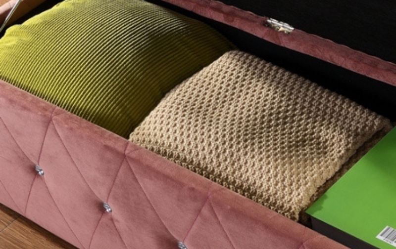 Dusty-pink-open-blanket-box-with-cushions.