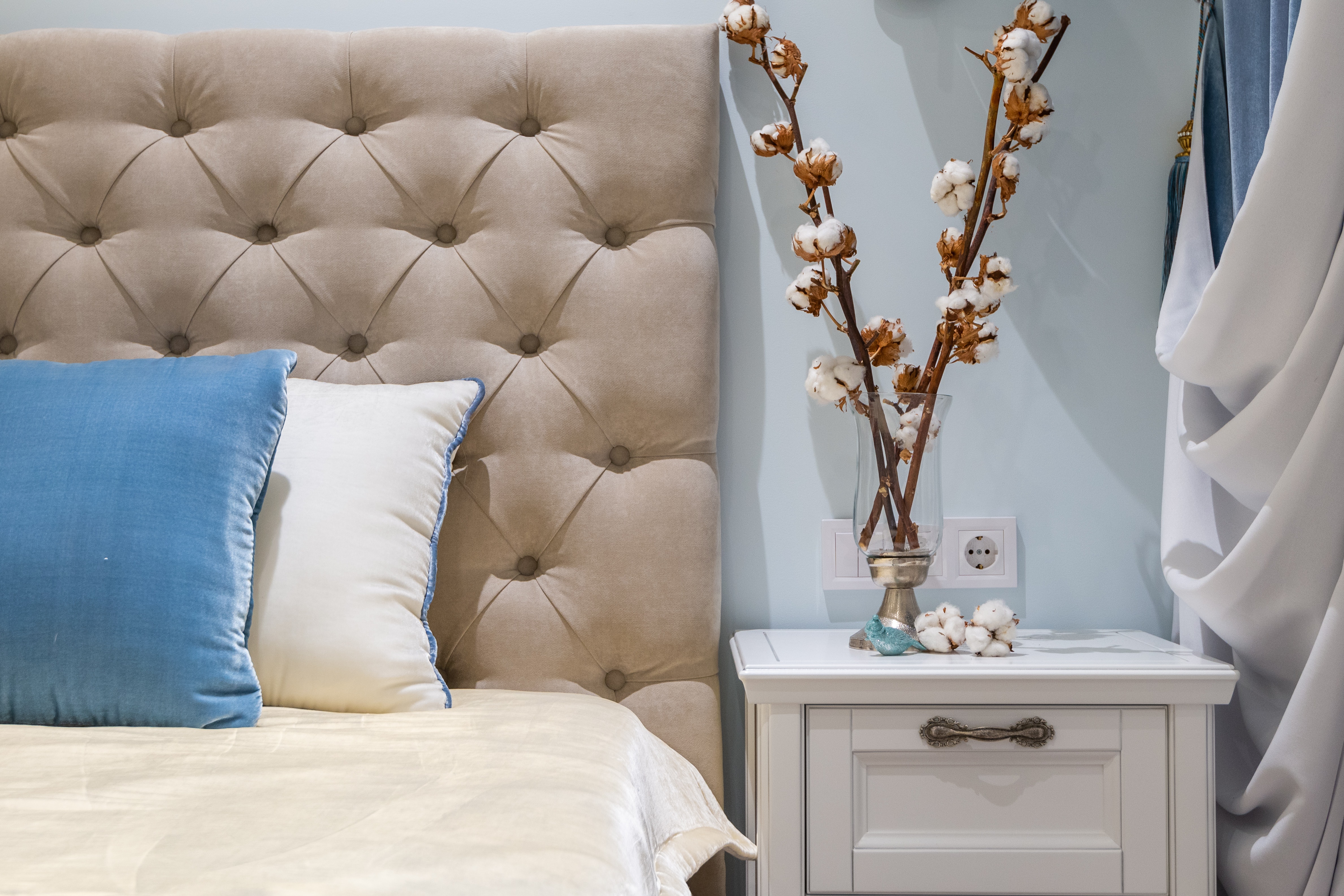 Light beige tufted headboard.