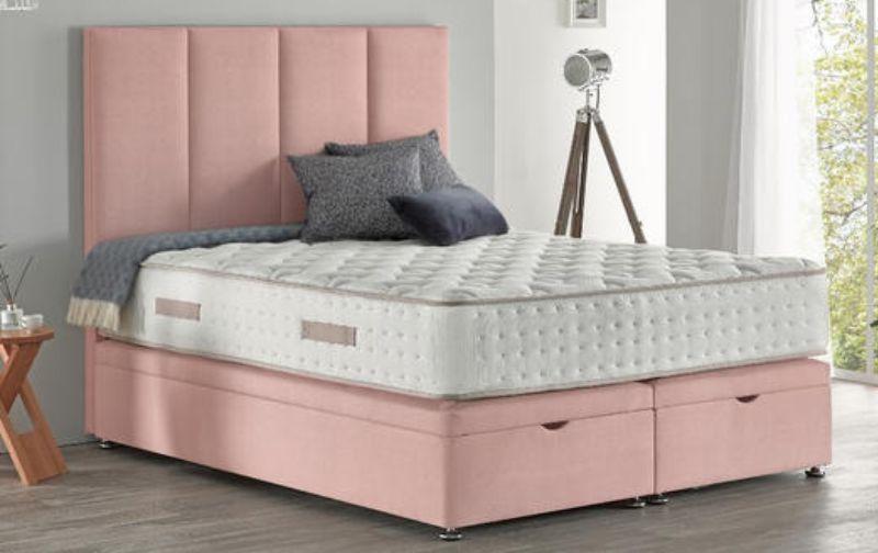 Mattress on dusky pink velvet paneled bedframe.