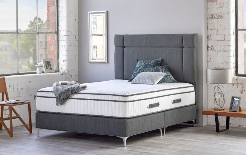 Panelled mattress on grey bedframe with silver legs.