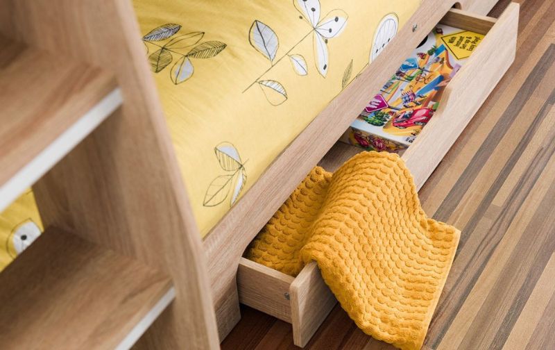Children's trundle bed with open drawer, yellow duvet and throw.