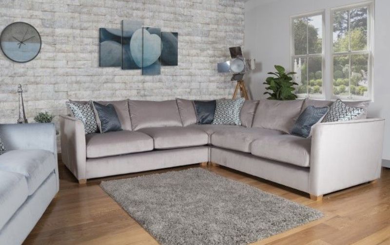 Light grey corner sofa with cushions.