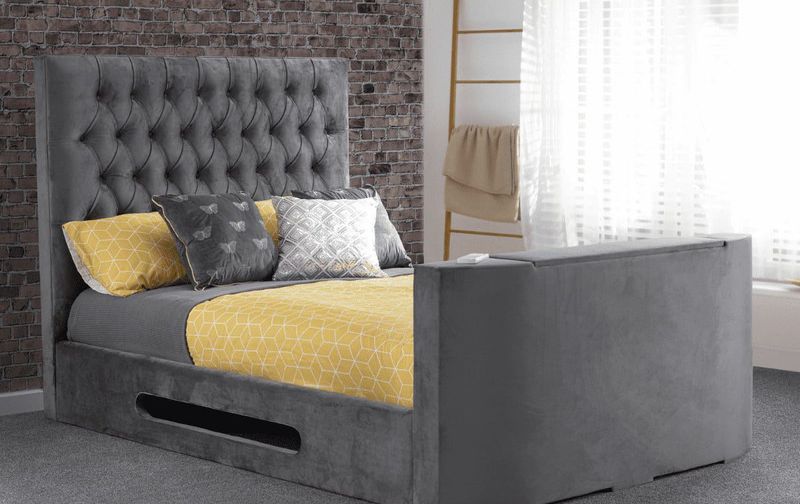 Yellow and grey bed linen on grey fabric bed frame.